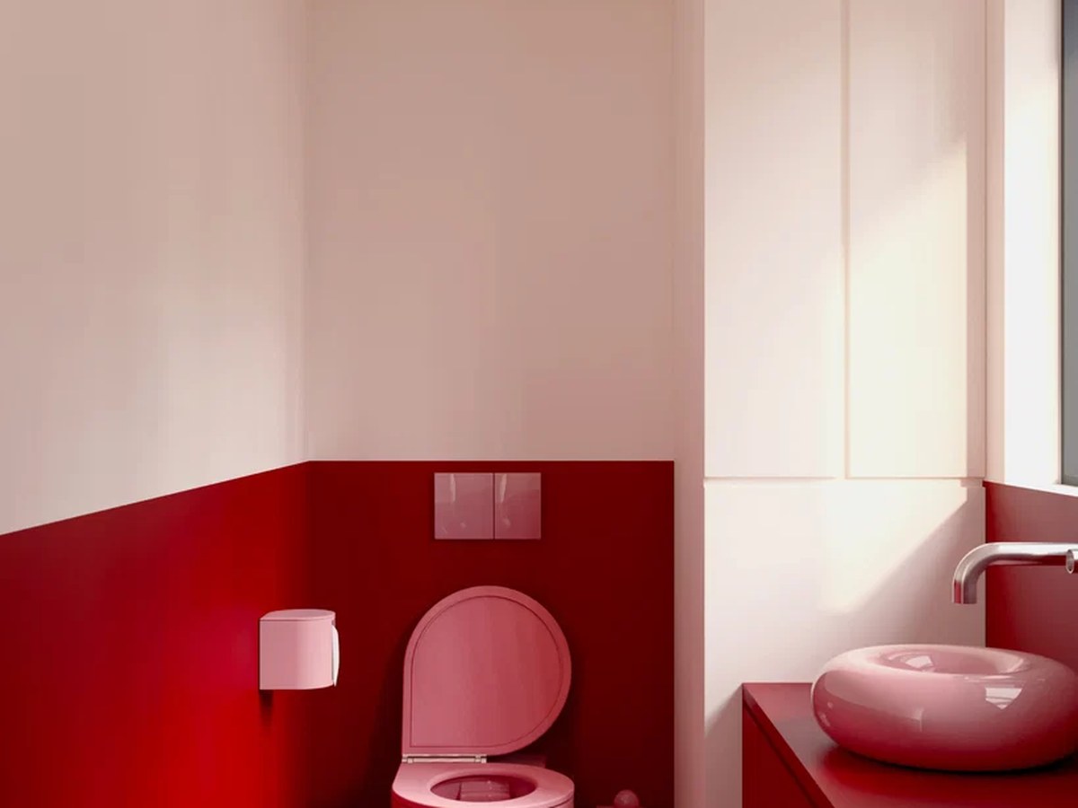 Toilettes design Trône rose dans une petite salle d’eau rouge avec vasque assortie